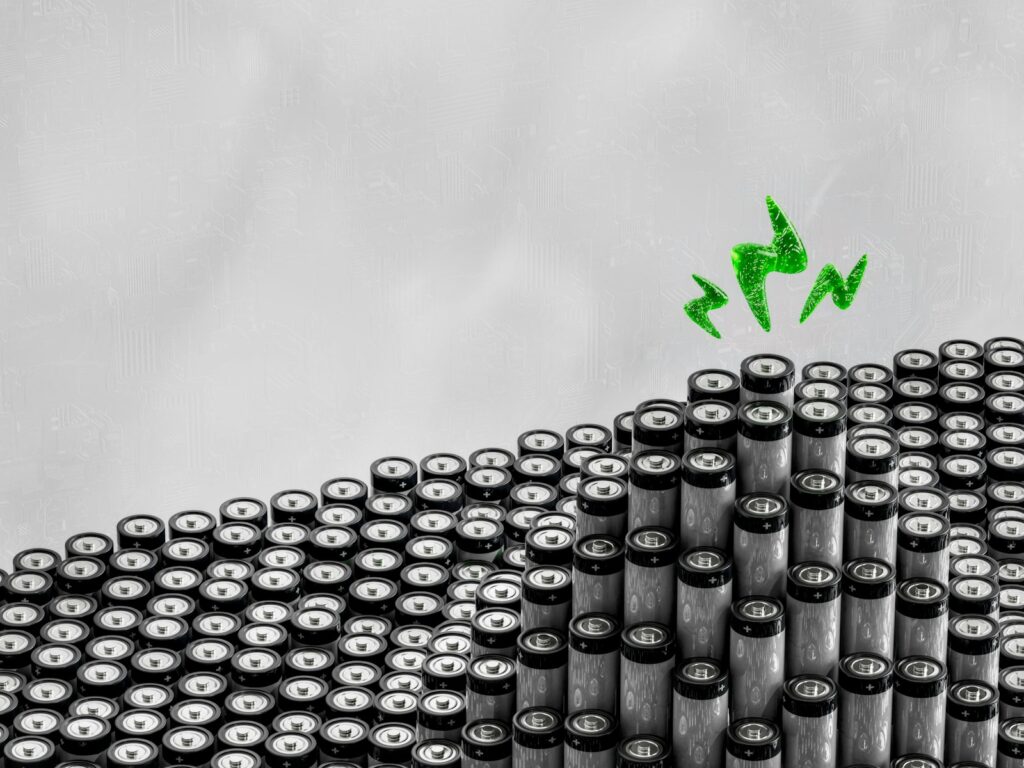 A bunch of black and white objects with a green arrow above them